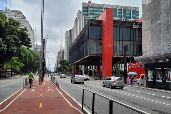 View of the São Paulo Museum of Art (MASP) on Avenida Paulista, showcasing its iconic modernist design with red beams and glass structure.