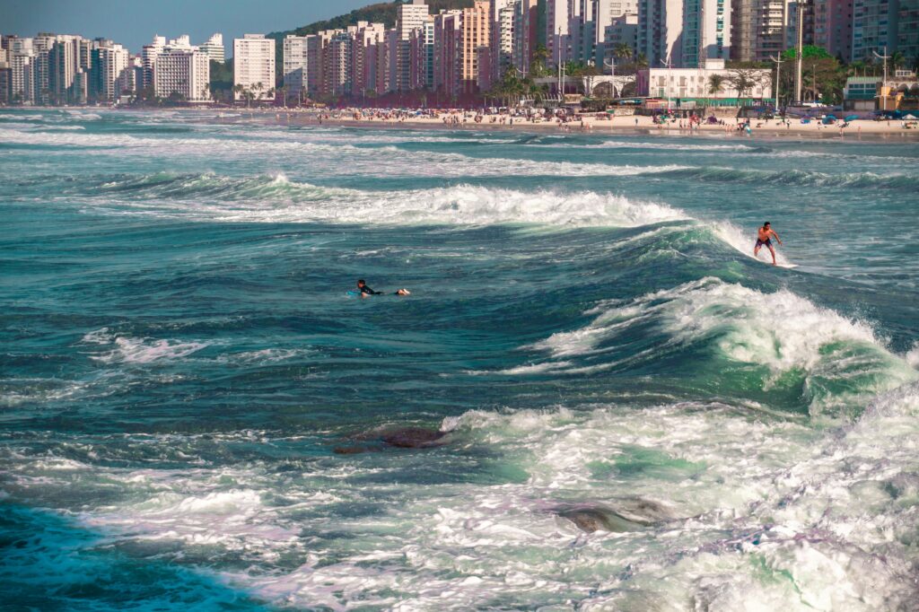 Surfers at a beach in Bertioga (Source: Pexels)