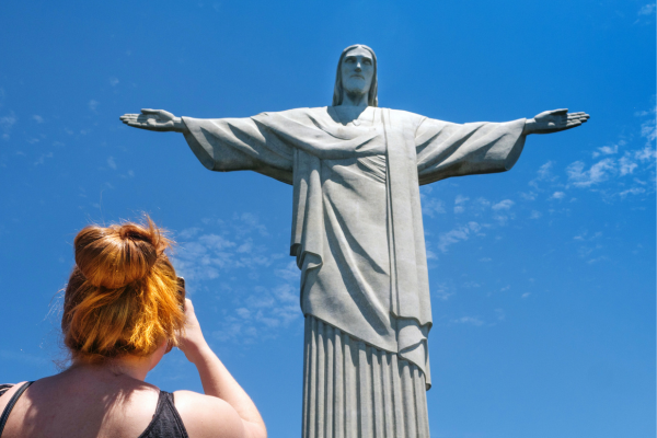 Woman taking a photo of Christ the Redeemer