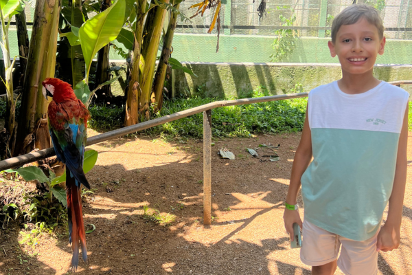 João and a macaw at the Bird Zoo in Poços de Caldas (Source: Personal Archive)