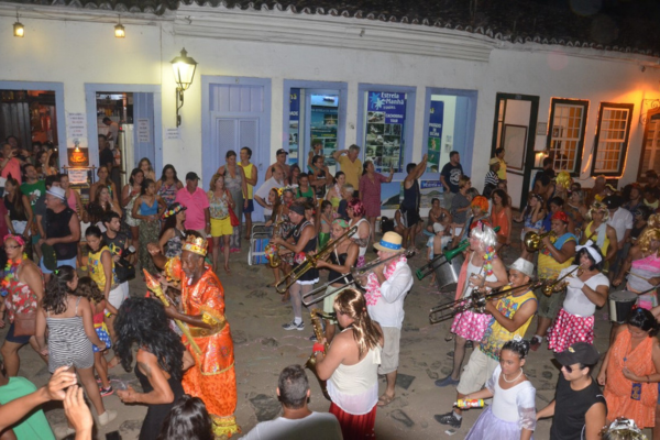 Street band performing during Paraty Carnival in the historic center with crowd dancing