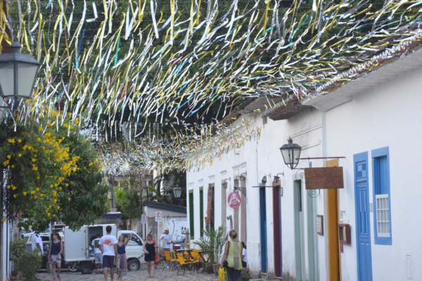 Colorful Carnival decorations hanging above cobblestone street in Paraty’s historic center, Brazil