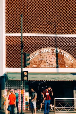 Exterior view of Mercado Central, Belo Horizonte, featuring people and vibrant storefront.