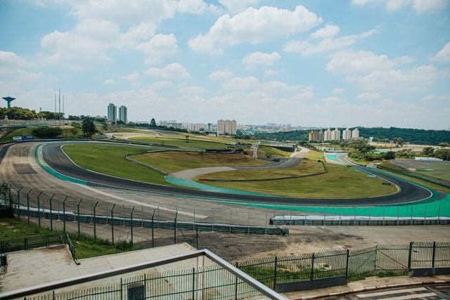 Spectacular aerial view of Interlagos racetrack in São Paulo, Brazil, under a bright sky.